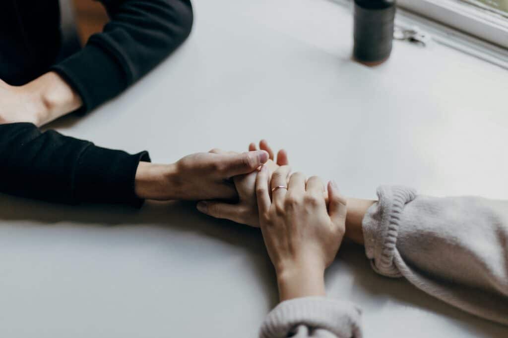 couple holding hands during couples counseling.