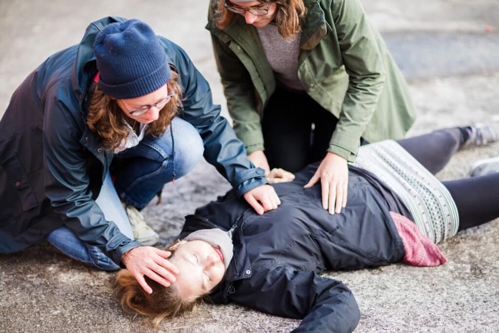 People helping someone who has overdosed.