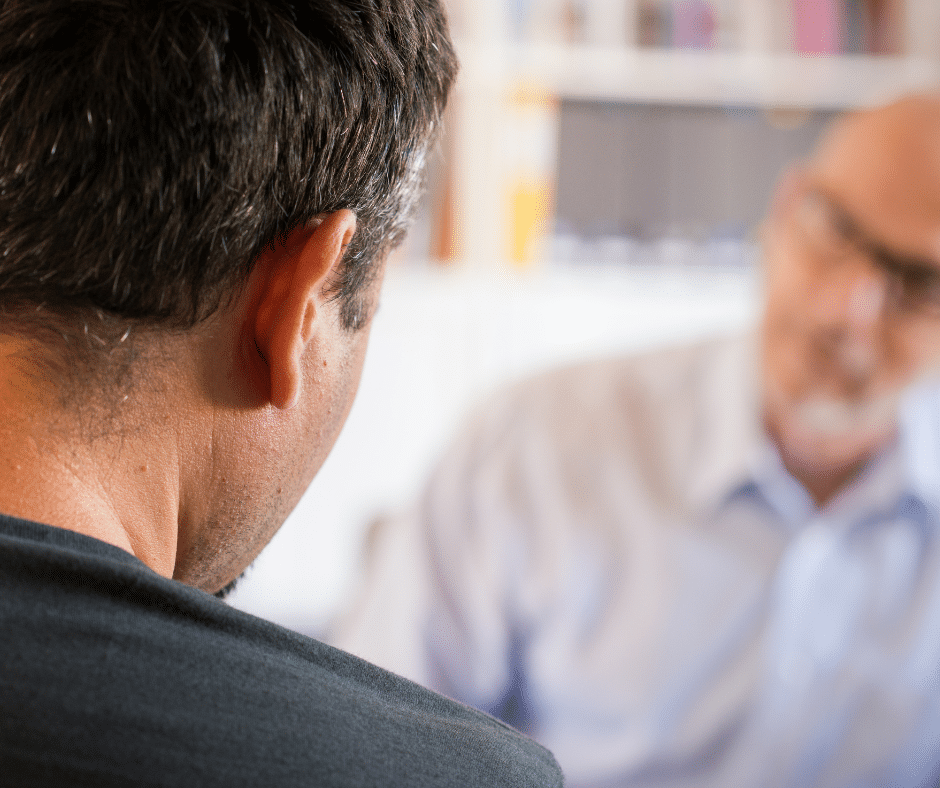 A man engaged in a conversation with a counselor during an individual counseling session.