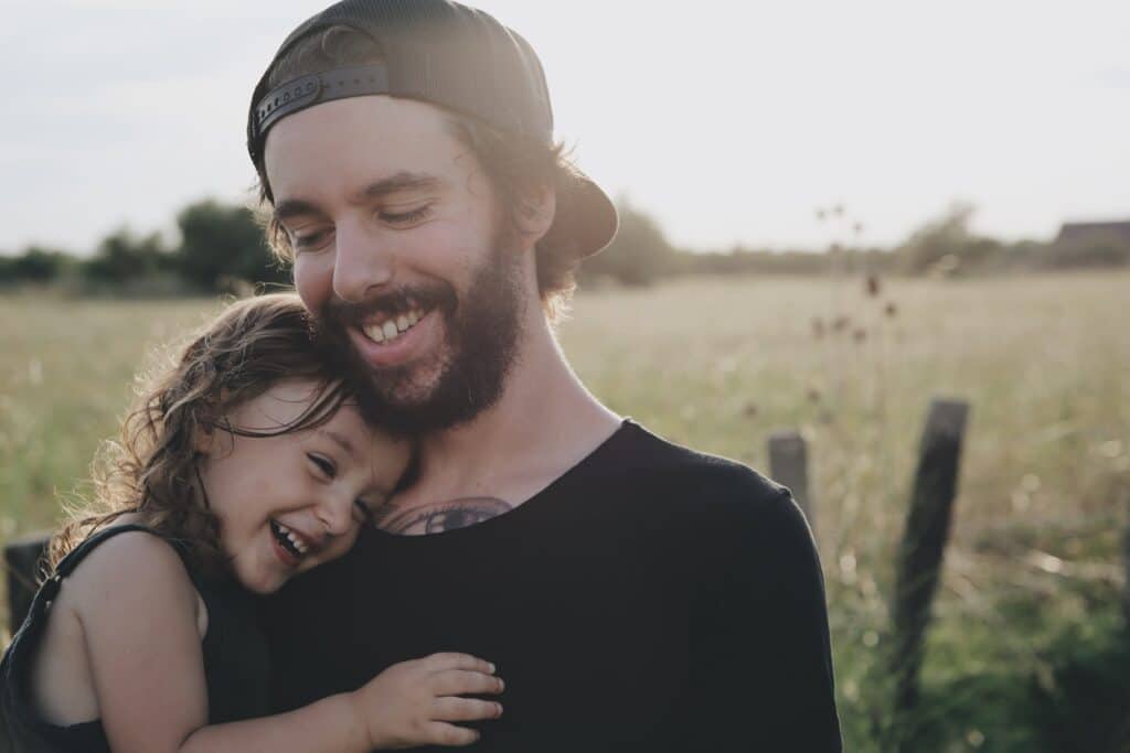Man happy with his child in recovery using suboxone treatment.