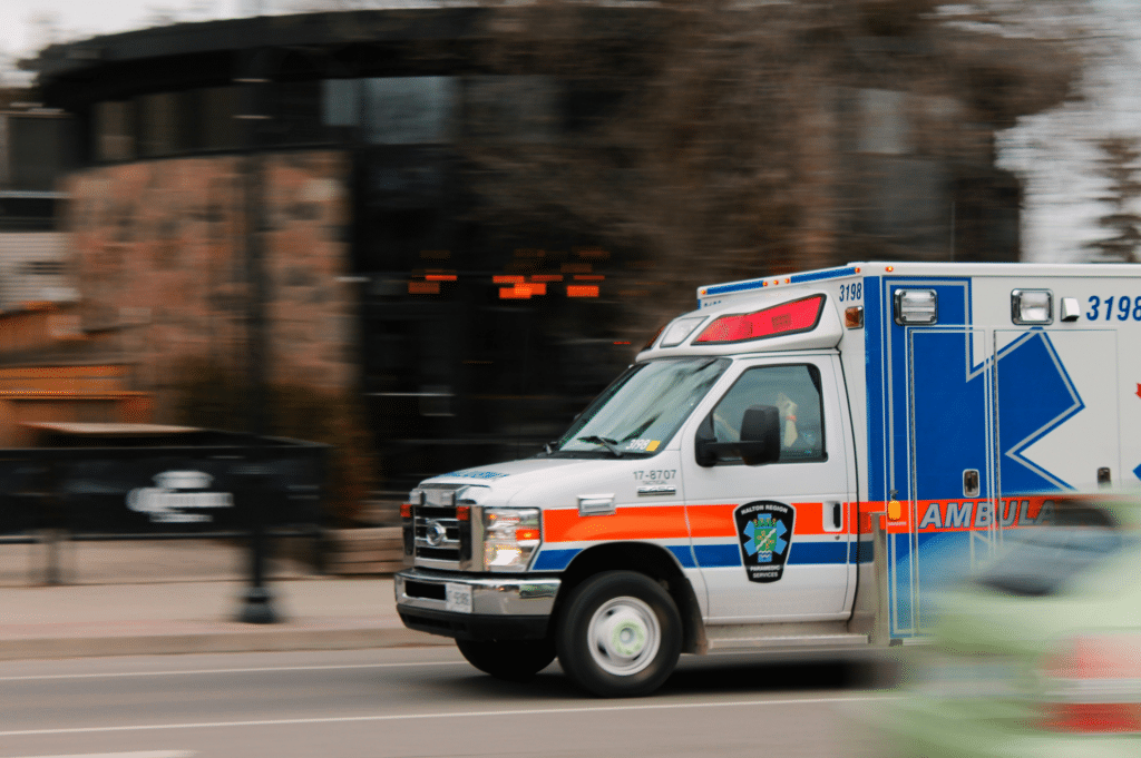 An ambulance with its lights flashing races to an emergency, possibly to an overdose situation.