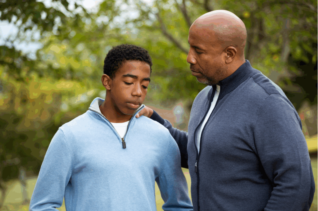 man co-parenting and talking to his son about his addiction.